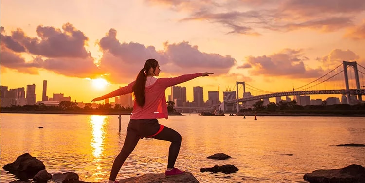 Virtual office at Servcorp where client enjoys a yoga session, knowing she can manage work from anywhere.