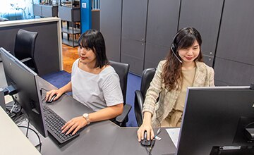 Receptionist helping clients at the front desk